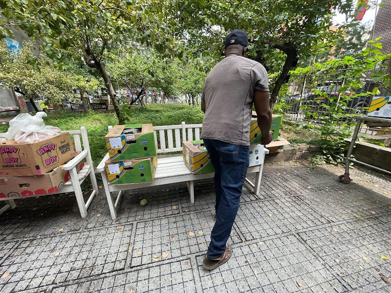 Volunteer carrying supply boxes through the outreach space